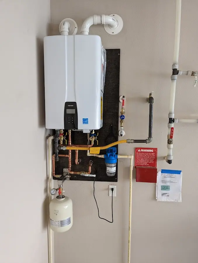 Professional plumber installing copper piping in a Orland Hills home